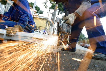 man at work grinding steel