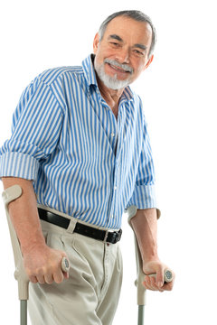 senior man on crutches smiling