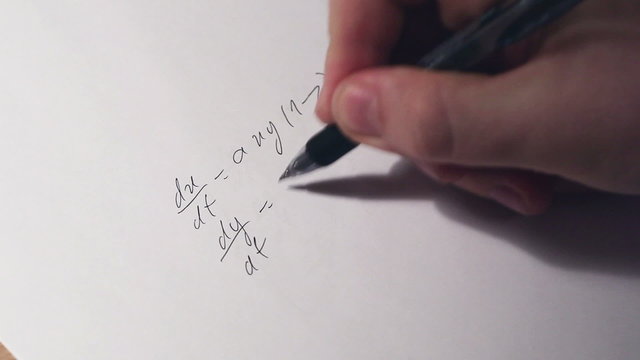 Writing math equations on paper. Fast motion effect.