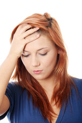 Fototapeta premium Woman with headache holding her hand to the head