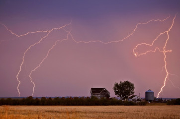 Lightning bolts seen behind Saskatchewan farmyard