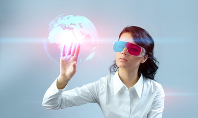 Touching 3D globe. Brunette in anaglyph stereo glasses.