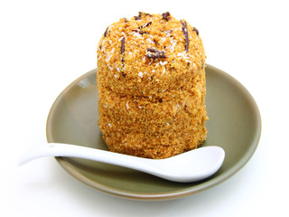 Honey cake with chocolate on a white background