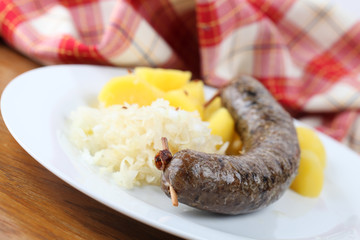 Traditional Czech white pudding with potatoes and sauerkraut