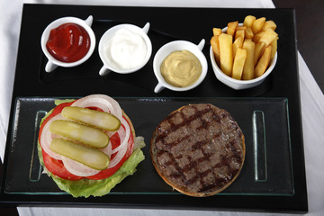 Burger french fries and sauces from top view