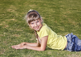 Fototapeta premium Child lying on green grass .