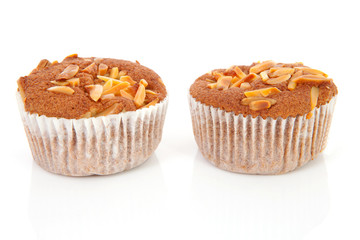 two biscuit cupcakes with nuts over white background