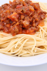 Spaghetti bolognese on a plate on a white background
