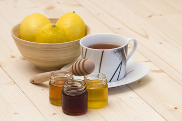 cup of tea, honey and fresh lemons