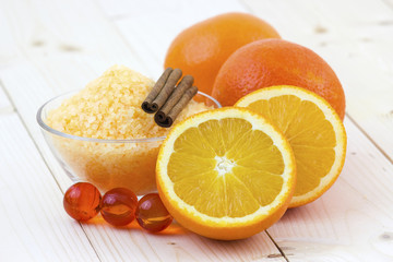 bowl of orange bath salt with fresh fruits - beauty treatment