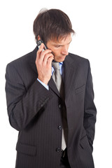 Thoughtful mature businessman talking on the phone
