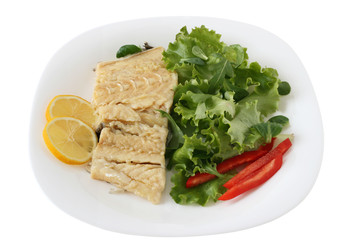 boiled codfish with salad, pepper and lemon