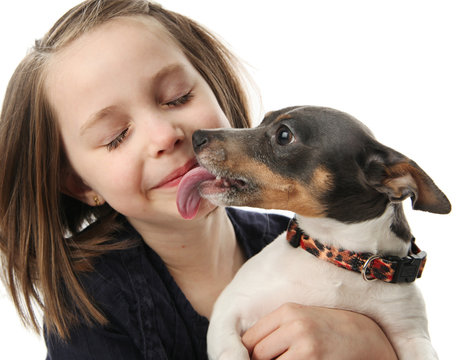 Girl getting kisses from dog