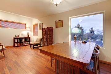 Room with large wood table and reading area