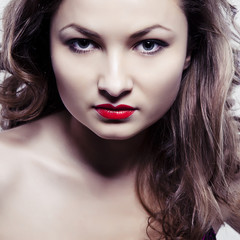 Fototapeta premium Young beautiful woman with long curly hairs