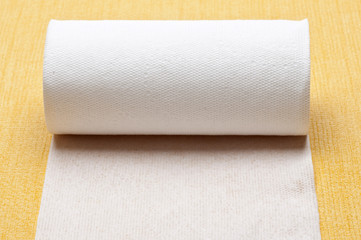 Roll of Toilet Paper on Yellow