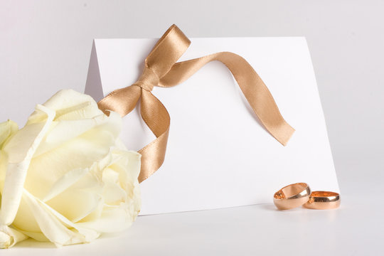 Wedding rings and invite with rose