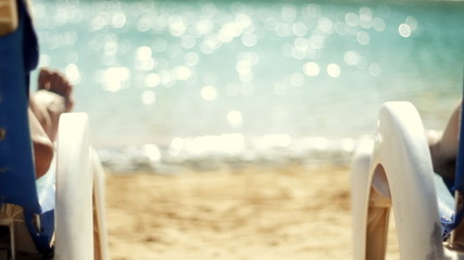 Rear view of a couple having drinks by the pool - Powered by Adobe