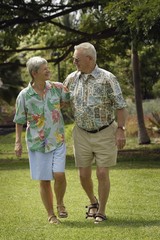 Senior Couple Walking In Field