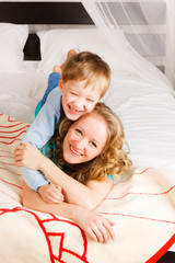 Obraz na płótnie Canvas woman with a son on a bed