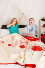 woman with her son on a bed © OlgaKhorkova
