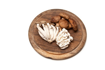 Exotic mushrooms on a wooden board.