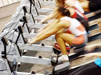 Women exercising in the gym on rowing machines