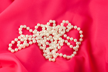 pearl necklace on red silk