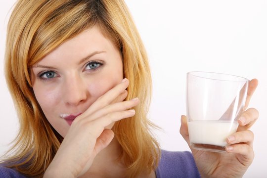 beautiful blond woman with a glass of milk