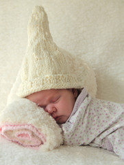 Monthly Redhead baby sleeping on a white blanket