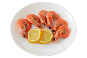 boiled shrimps with lemon on a plate