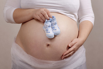 Mother has a baby shoes