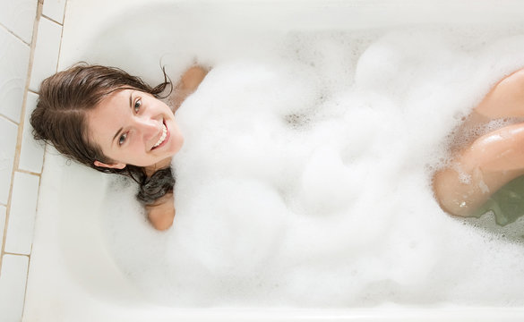 girl in a bath with  foam