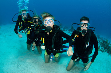 family scuba diving together