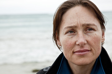 Attractive woman at beach with thoughtful expression