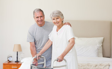 Man helping his wife to walk