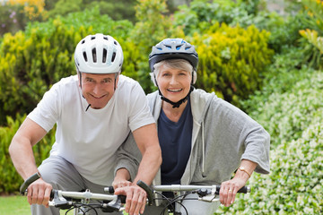 Mature couple mountain biking outside