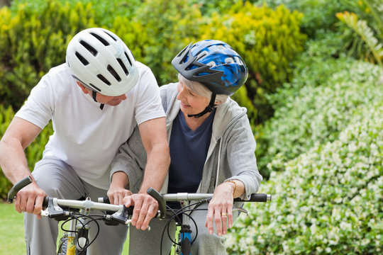 Mature Couple Mountain Biking Outside