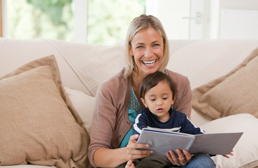 Mother looking at a book with her son