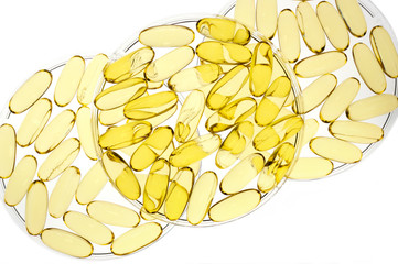 Petri dishes containing gold gel capsules