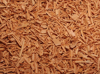 Shavings of juniper on a table as background