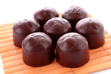 Chocolates on wooden surface isolated