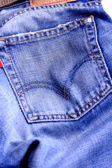 Fragment of blue modern jeans with pocket, can be used as a back