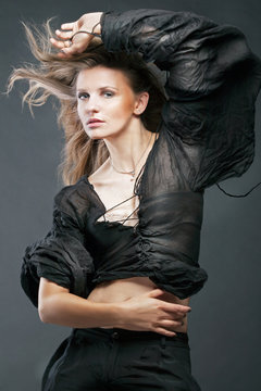 Attractive fashion model posing on dark background.