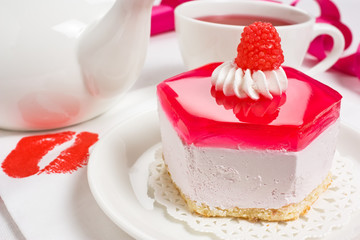 Biscuit cake with whipped cream, jelly and raspberry candy