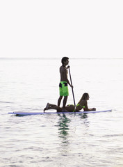 young couple on a paddleboard in a hawaii lagoon