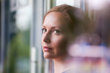 Beautiful woman looking through a window