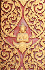 raditional thai style art carving at the door of temple