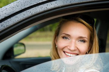 cheerful woman in the new car