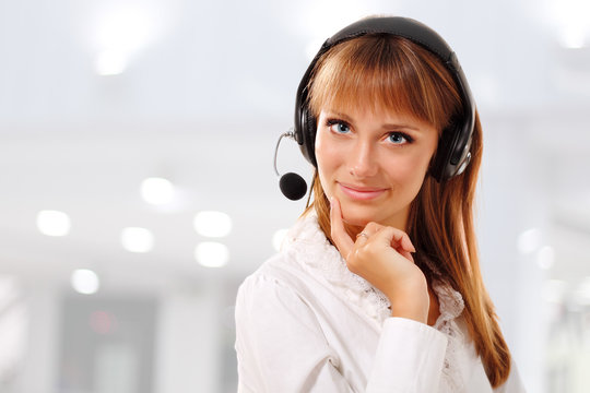 Support phone operator beautful young woman in headset at workpl